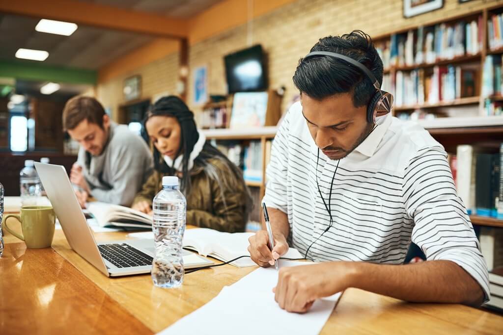 alunos estudando em biblioteca