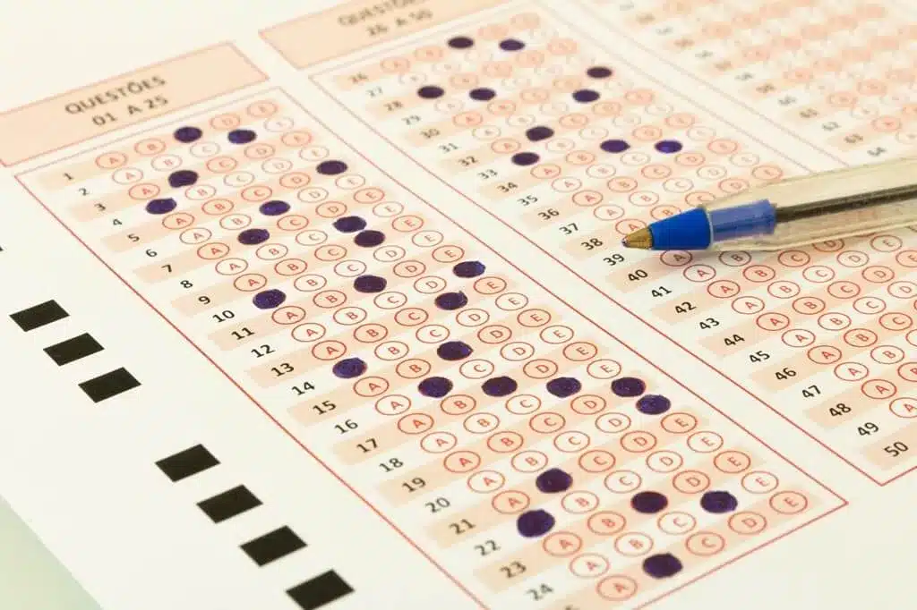 caneta azul em cima de gabarito